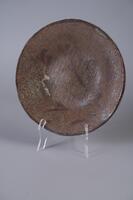 Large round plate with rough surface and a gloss footed base. Brown bamoo sumie on rust color matte glaze ground with grog bits added to clay, fired on nine kiln struts.