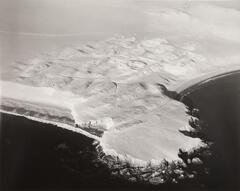 This photograph depicts an aerial view of a coastline.
