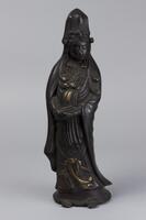 Bronze male figure, legs are slightly slanted, he is wearing a robe and hat.