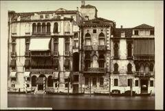 Photograph of fa&ccedil;ades of palazzos along the edge of a waterway.