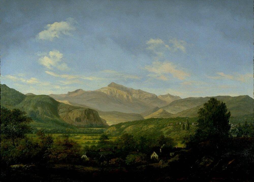 Landscape painting with mountain peak at center and rolling mountains to either side; valley in foreground with houses hidden among trees in deep shadow and along hillside; blue sky above with wispy clouds.