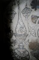 A color photo of wall paintings of vases.  Flowers and swirls are also painted around the vases.