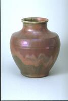 Large vessel with angled shoulder, large neck and mouth and rounded lip with iridescent glaze in dark rose and brown colors