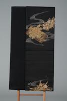 <p>Black Fukuro (double-sided) obi with interwoven light brownish gray swirling water ripples and brown rafts with embroidered gold and yellow flowers.</p>
