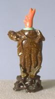 A glass snuff bottle, brown with gold specks, in the shape of the Buddha&#39;s Hand fruit. On the top is a turquoise collar with a coral stopper in the shape of a stem.