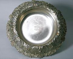 Silver dish-shaped piece with very large flared lip covered with opulent repouss&eacute; decoration