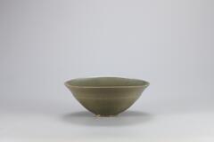 <p>This bowl is typical of early-Goryeo celadon in terms of shape and pattern. Similar examples have been excavated from sedimentary layers from the Kiln no. 10 at Yongun-ri, Gangjin-gun, Jeollanam-do. The entire inner wall is decorated with chrysanthemum sprays incised in fine lines. Chrysanthemum spray design is commonly found in Goryeo celadon produced between the 10th and the 11th centuries along with the motifs of chrysanthemum, scroll, cloud, parrot, and wave. The design is resemblent to those found in Yue ware, but the clay and glaze were sintered better and the glaze was exquisitely fused to turn into the beautiful color without crackles. Six refractory spurs were used to support the bowl during firing. The bowl was restored after a breakage into two halves.<br />
[<em>Korean Collection, University of Michigan Museum of Art </em>(2014) p.92]</p>
<br />
Stoneware bowl with celadon glaze. The bowl is decorated by an incised line stretching parallel to the rim, bounding a chrysanthemum design below.