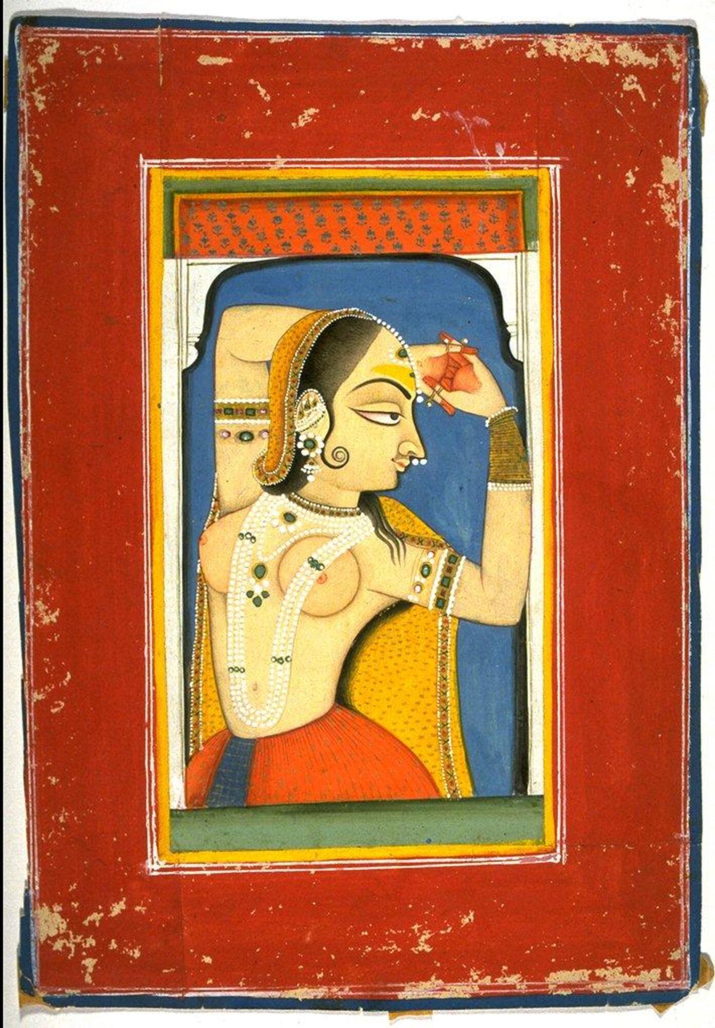 A bejewelled nayika holds an amorous pose. The portrait is focused on her upper body and side face.