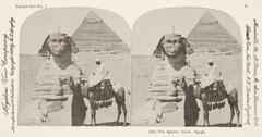 This black and white stereoscopic image features two images of two men, one man sitting on a camel, in front of a sphinx and a pyramid.