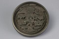 Steel dish with ornate floral and fauna scene on inside.