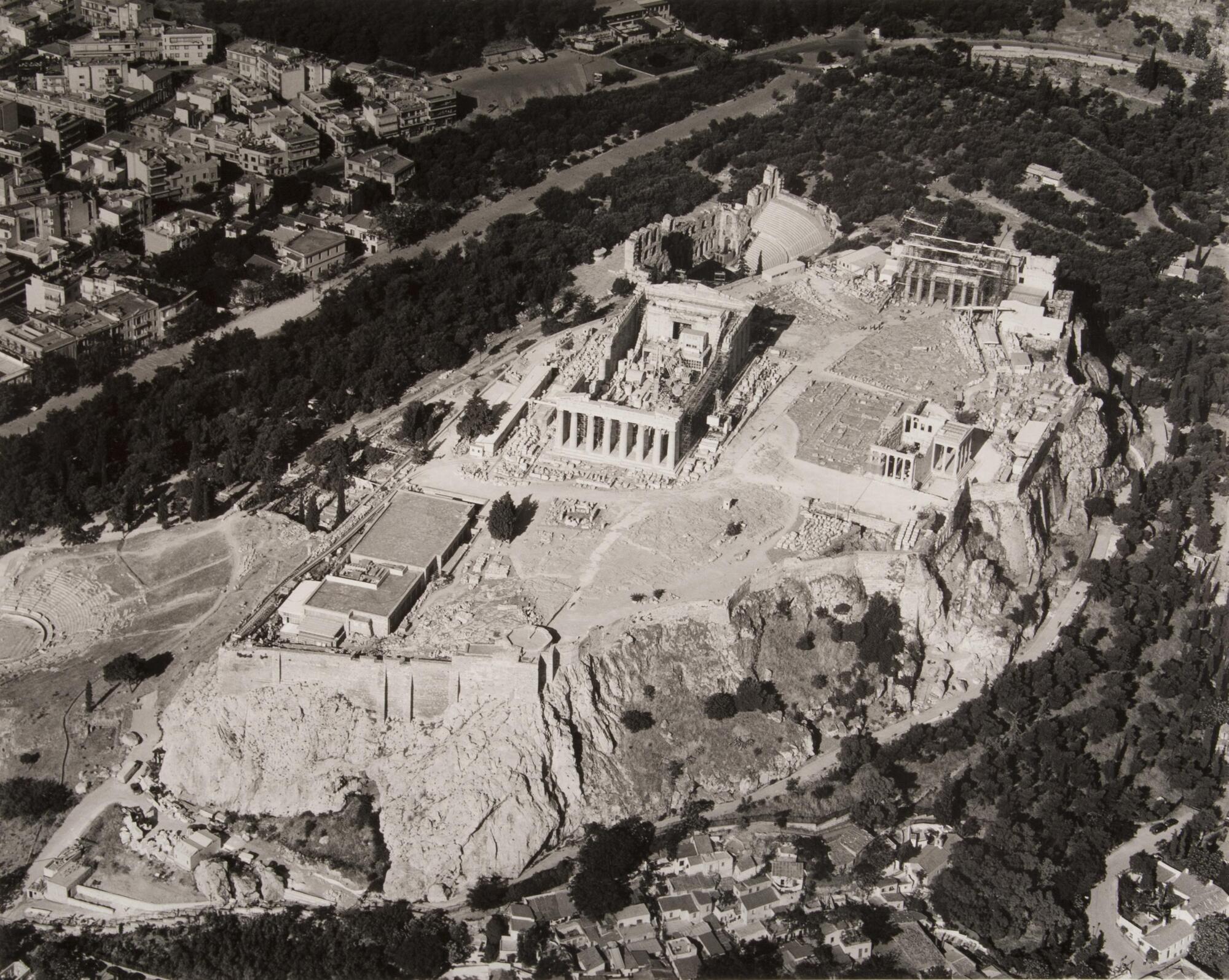 This photograph depicts an aerial view of a hilltop full of ancient monuments.