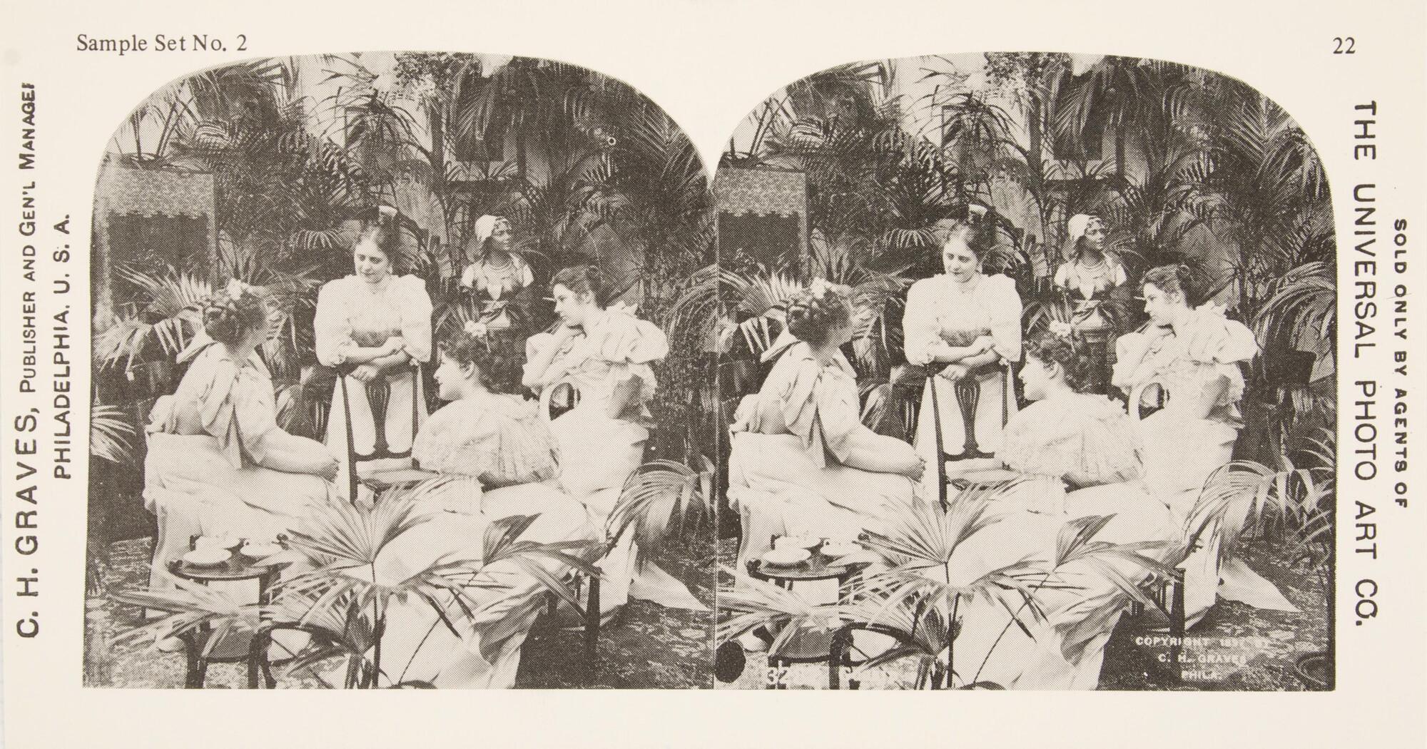 This black and white stereoscopic image features two images of four women sitting together outside in white dresses. Around them are tropical plants, a statue of a female head and bust and a small table with teacups in the lower left.