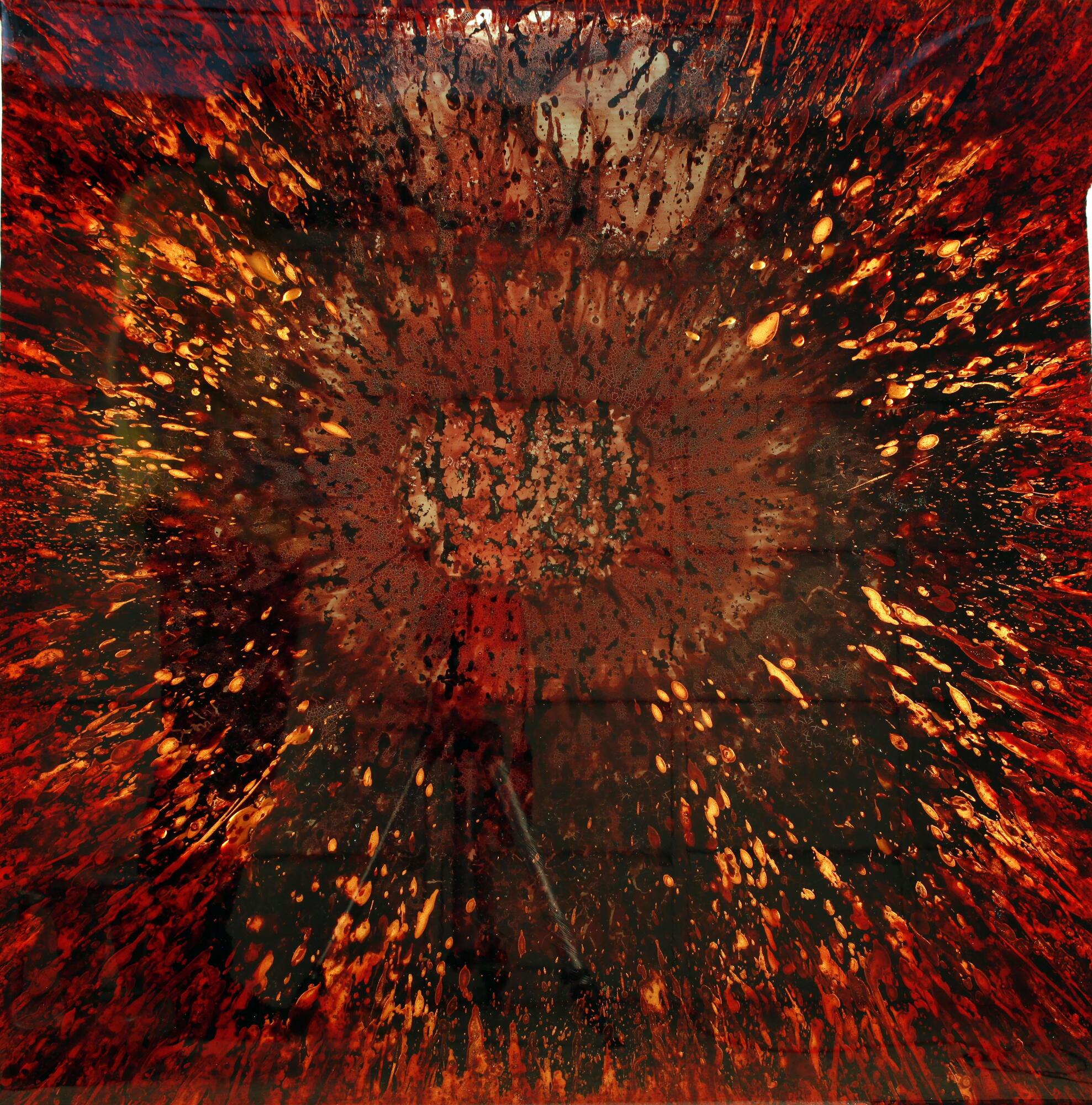 An abstract painting of blood in a sunburst pattern.