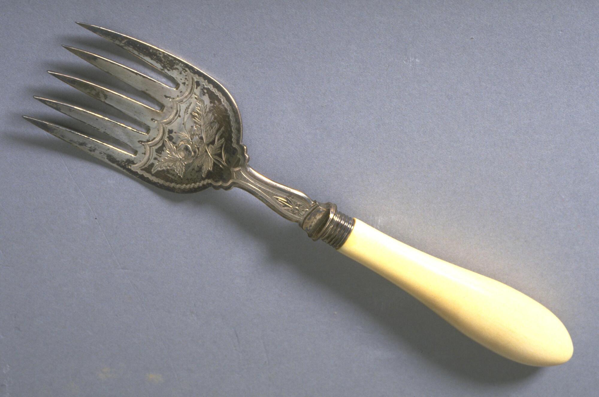 Five-tined engraved silver fork with ivory handle