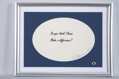 The phrase "Do you think Fluxus made a difference?" is digitally printed on paper and signed by artist then placed in a mass produced frame with a googly-eye sticker in the lower right corner. 