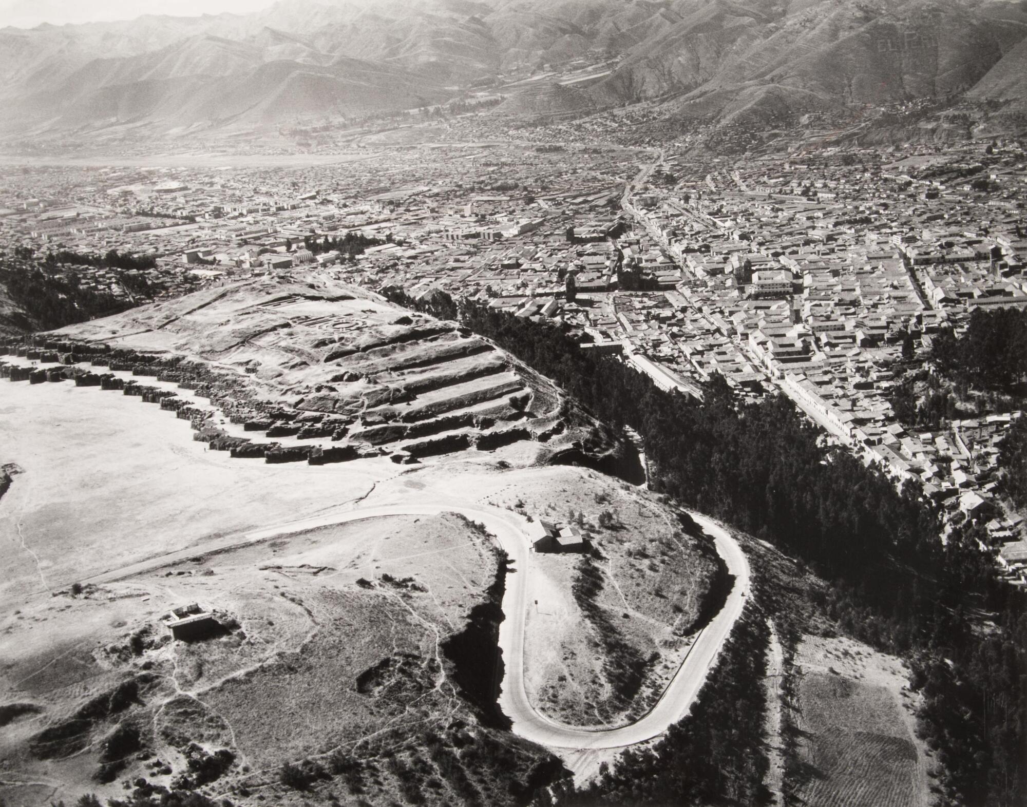 This photograph depicts an aerial view of an ancient citadel overlooking a city.