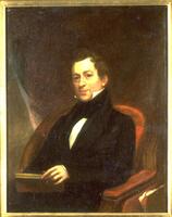 Half-length portrait of man wearing a black suit and black cravat. Subject sits in a chair of wood and red textile set against a dark curtain. He looks outwards and holds a book with his left hand. (Larson 2/5/18)<br />
&nbsp;