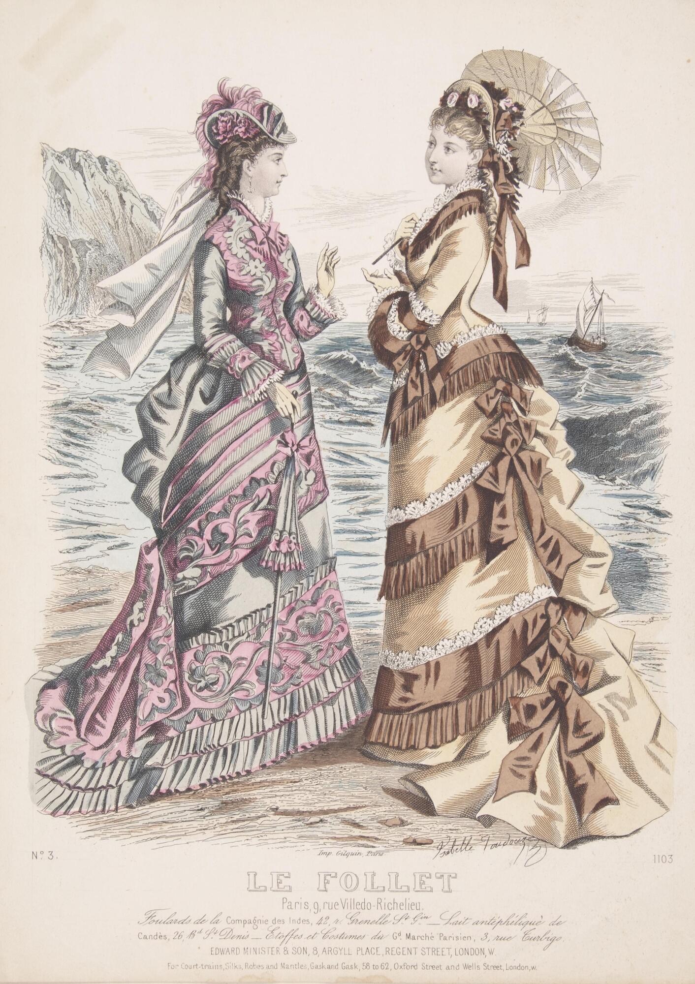 This colored engraving features two women in elaborate dress on a beach with a wavy ocean behind them. The woman on the left wears a blue dress accented with pink and a hat in the same colors. The woman on the right wears a beige dress accented in brown and white and a hat in the same colors decorated with flowers. She also holds a small parasol above her head. The women appear engaged in conversation as they both gesture with their hands. In the distance in the water on the right there are three ships. On the left in the distance a rock formation is depicted.