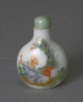 A circular milk glass snuff bottle. Depicted on the surface of the snuff bottle is a man sitting cross legged in a garden. On the top of the snuff bottle is a mouthpiece with a green stopper.