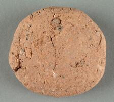 Disk of coarse refractory, ceramic clay.