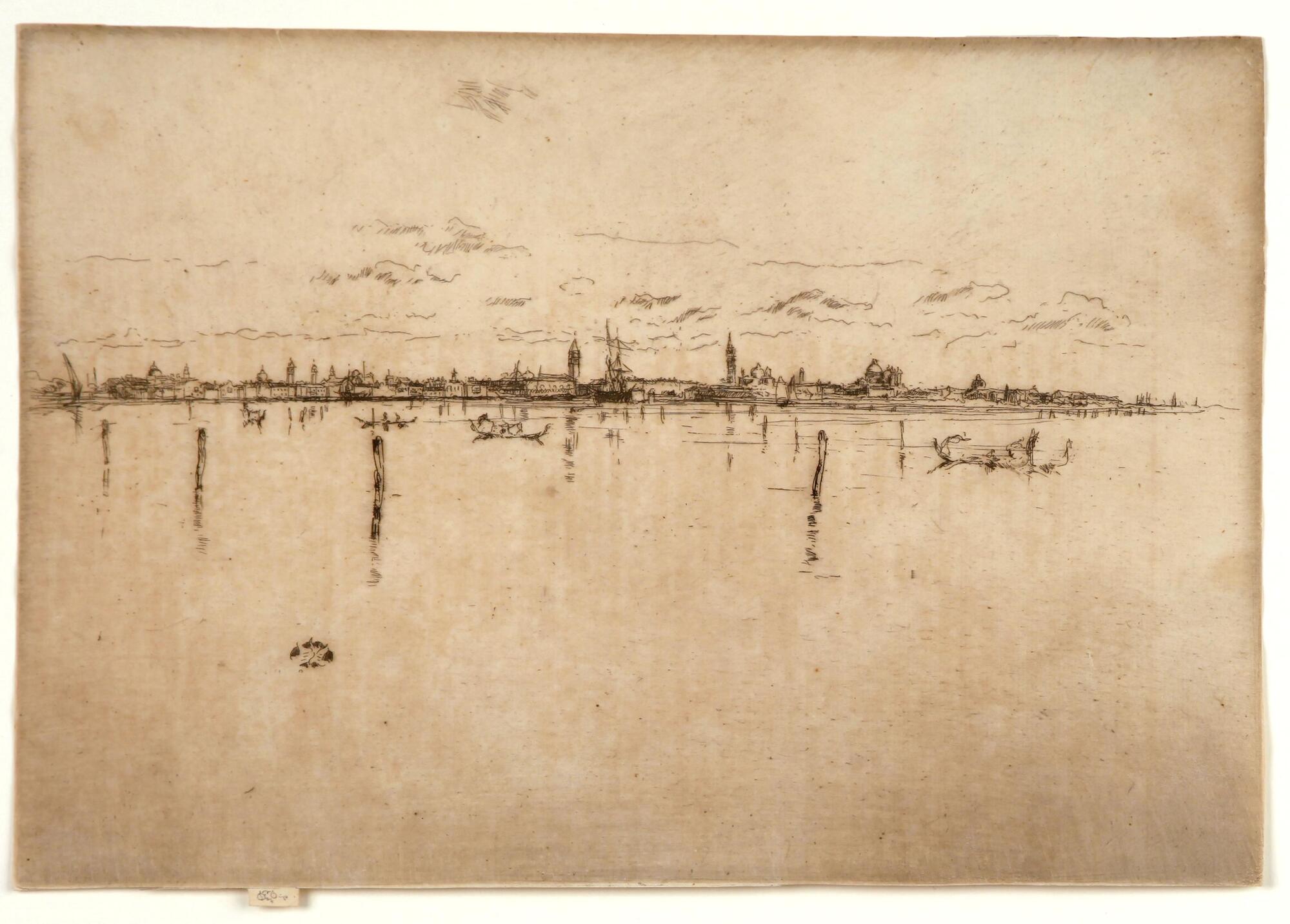 Seen from a distance with an expanse of water in the foreground, a city can be seen along the horizon line wtih towers, domes and sailing ships. Poles marking the channel stike out of the water and gondolas can be seen in the middle ground.