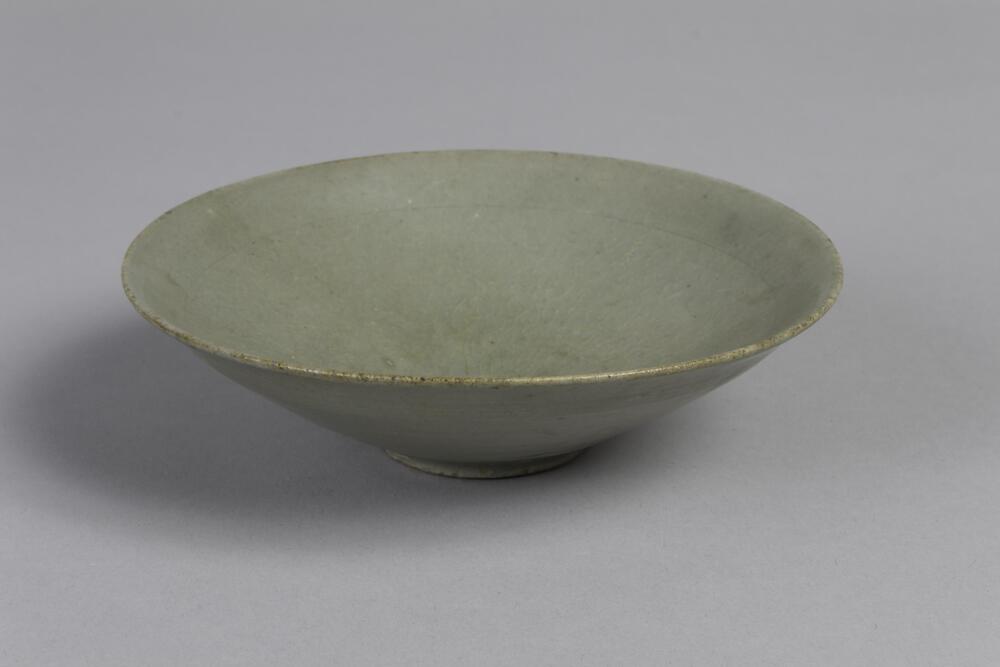 Glossy finish gray colored bowl. Contains a ring near the rim on the inside and an indentation in the center.
