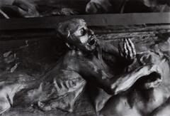 A bronze sculpture depicting a man with his mouth open.