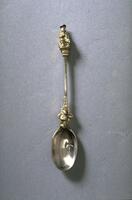 Silver spoon with figure of a man at the terminal end of the handle