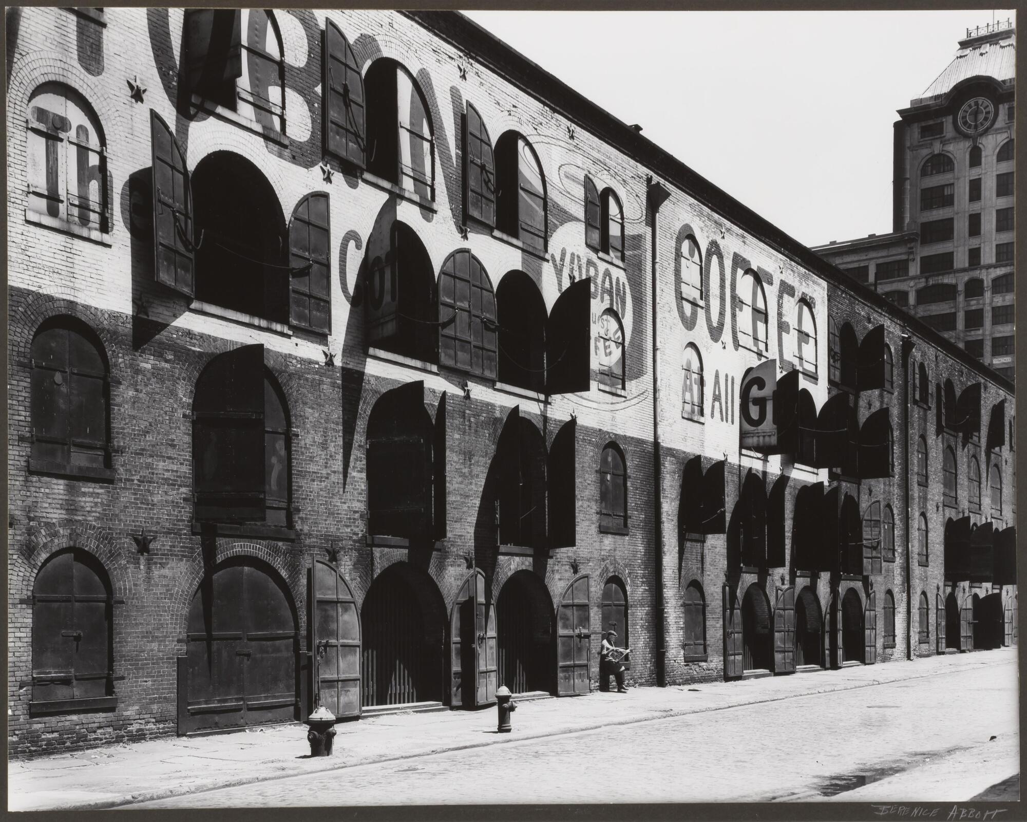 Oblique view of a warehouse building with open shutters.
