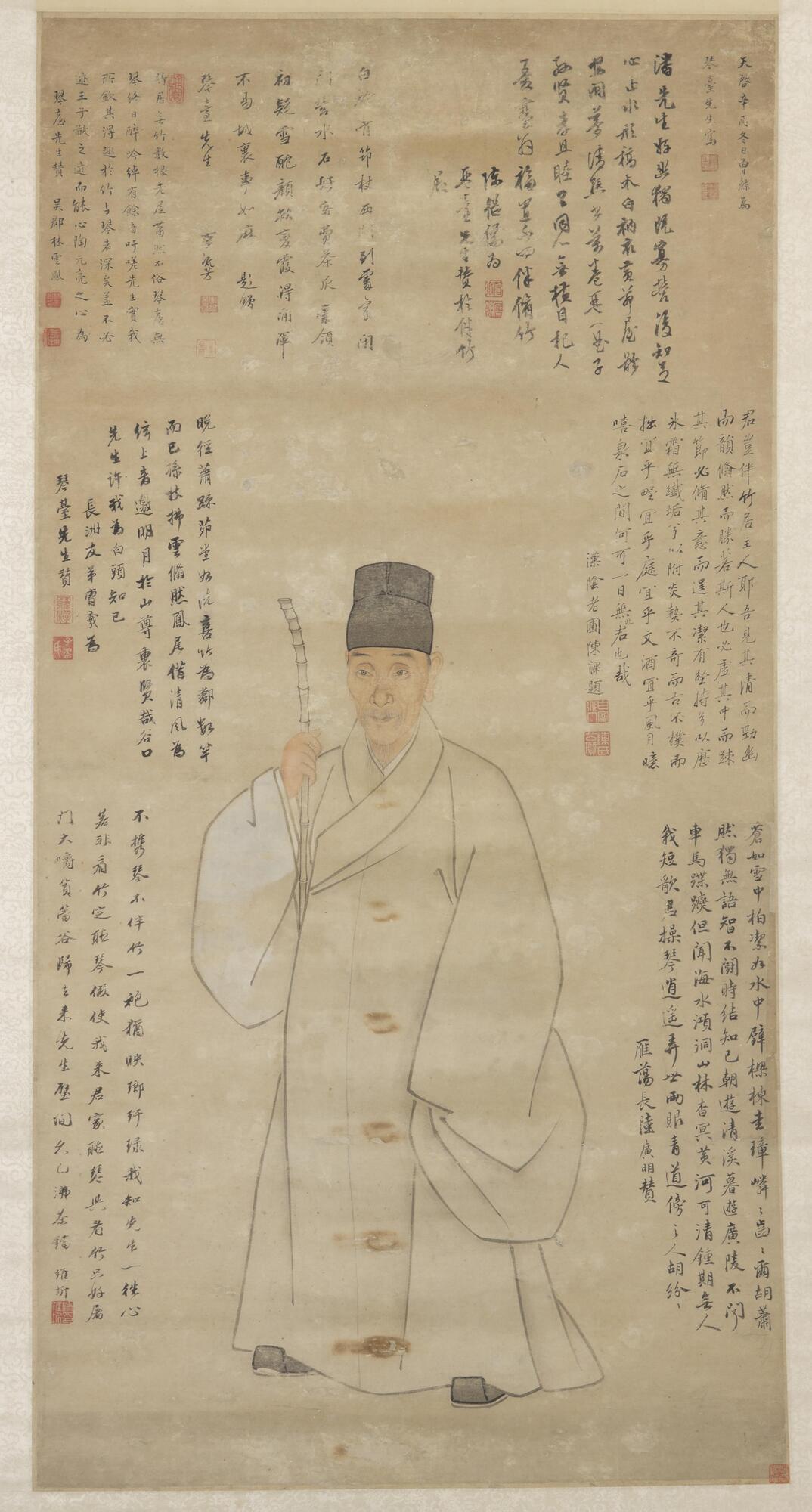 Painting of a standing male figure facing forward and holding a walking stick, against a blank background surrounded by an inscription, two artist’s seals, seven colophons and accompanying seals of contemporary scholars and artists. <br />