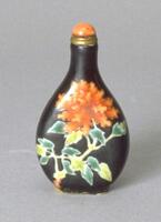 Snuff bottle with red peony design with forest and lime green leaves on black ground. It has a brass collar and a coral tinted ivory stopper.
