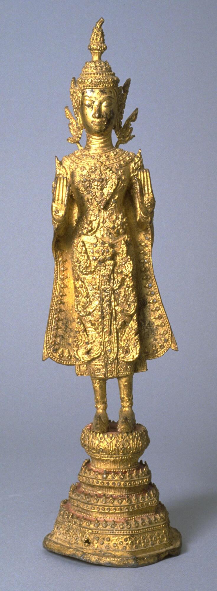 Gilded brass (or gilded copper alloy) standing Buddha on lotus pedestal with both hands raised in abhaya mudra.