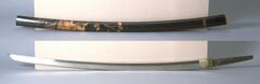The sword is long and slightly curved; the metal smith's name is engraved on the metal handle.