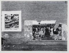 This is a photograph of the side of a building with two posters advertising a movie and circus.