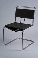 Cantilever chair frame formed by a continuous line of thin steel tubing (connected under the seat with an additional piece of tubular steel), with separate lengths of black canvas wrapped around it at the seat and back.