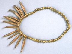 Belt with brass beads and curved pendants. Some pendants have sections that are wrapped in wire. 