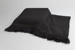 Solid black silk shawl with three inch black fringe, simply tied, not ornate.