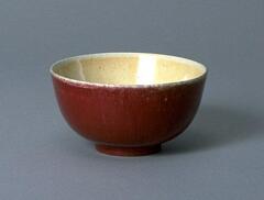 An &quot;ox-blood&quot; colored bowl on a footring.