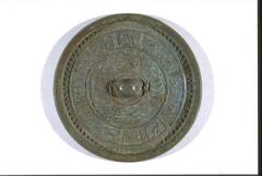 Bronze mirror with one side polished flat, and the other side decorated with mystical animals for cardinal orientation and twelve zodiac animals.
