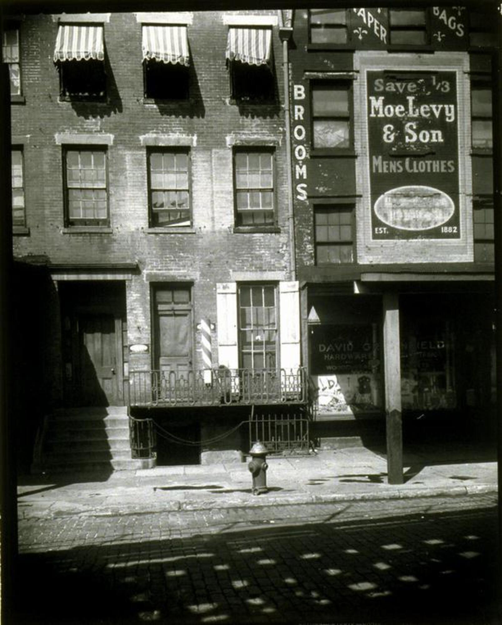 View of an empty street in front of a men's clothing store.
