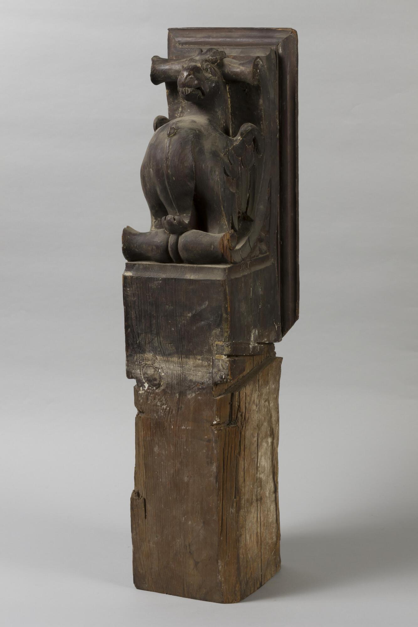 Carved animal figure on pedestal.
