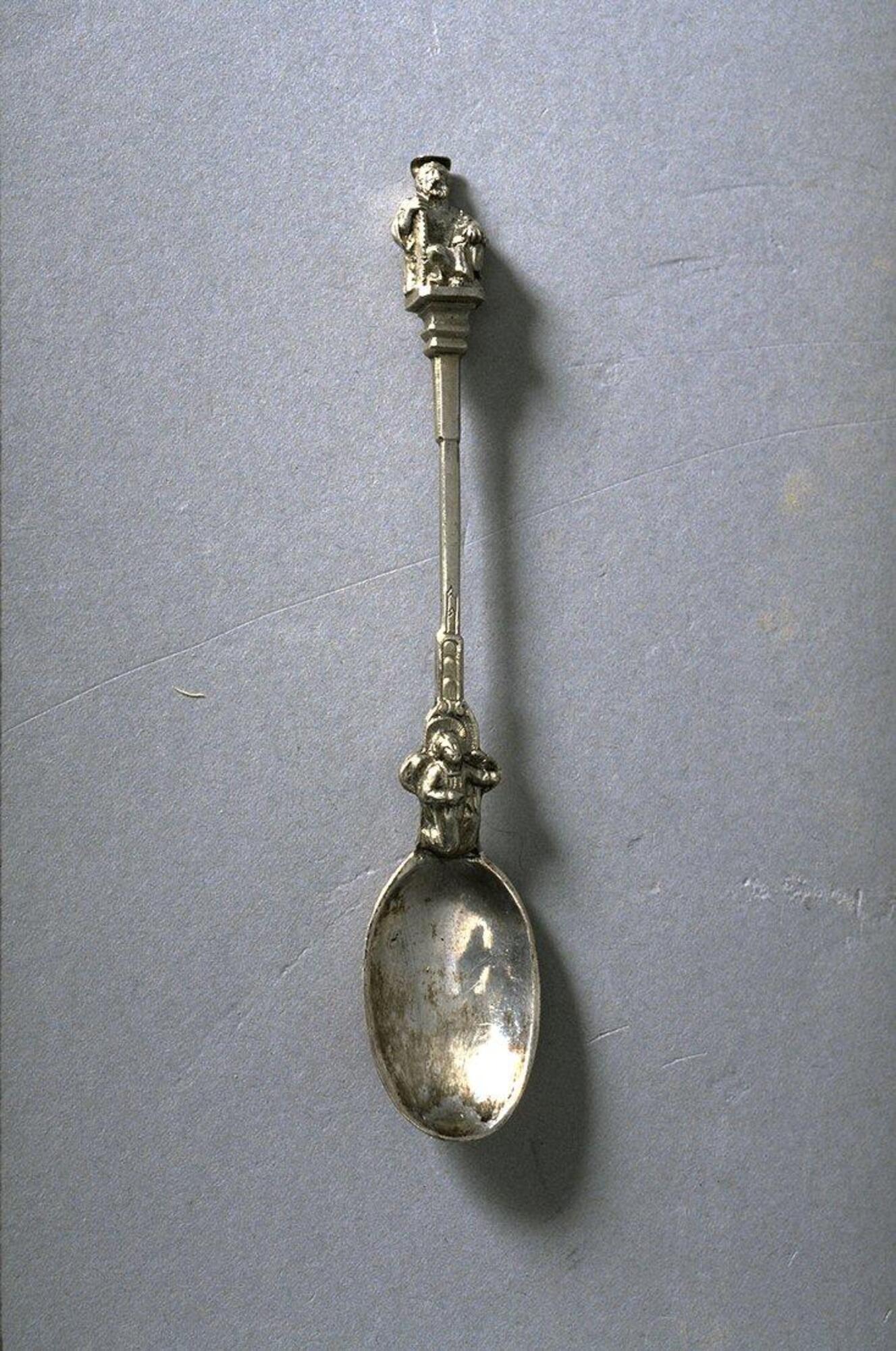 Silver spoon with figure of a man at the terminal end of the handle