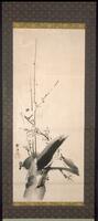 There are branches with plum blossoms coming from a tree. There is a signature and stamp on the left side of the hanging scroll. The hanging scroll is bordered with a brown design.