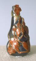 A jasper snuff bottle with two bulges on the body decorated with red leaves.