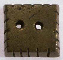 Geometric gold-weight in the form of a square base with notched edges and two holes in the center. 