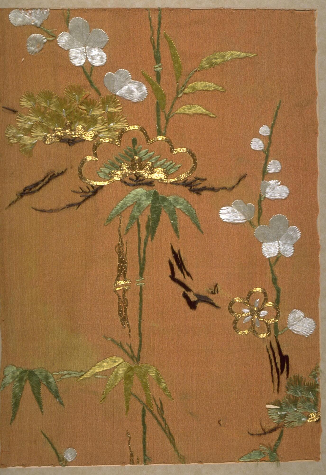 Kimono Fragment with an orange background that has green, gold, and white embroidered and couched designs of plum, bamboo and pine.