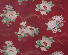 Maroon with pink flowers and green leaves. In the background there are yellow tractors. White stitching on the edges.