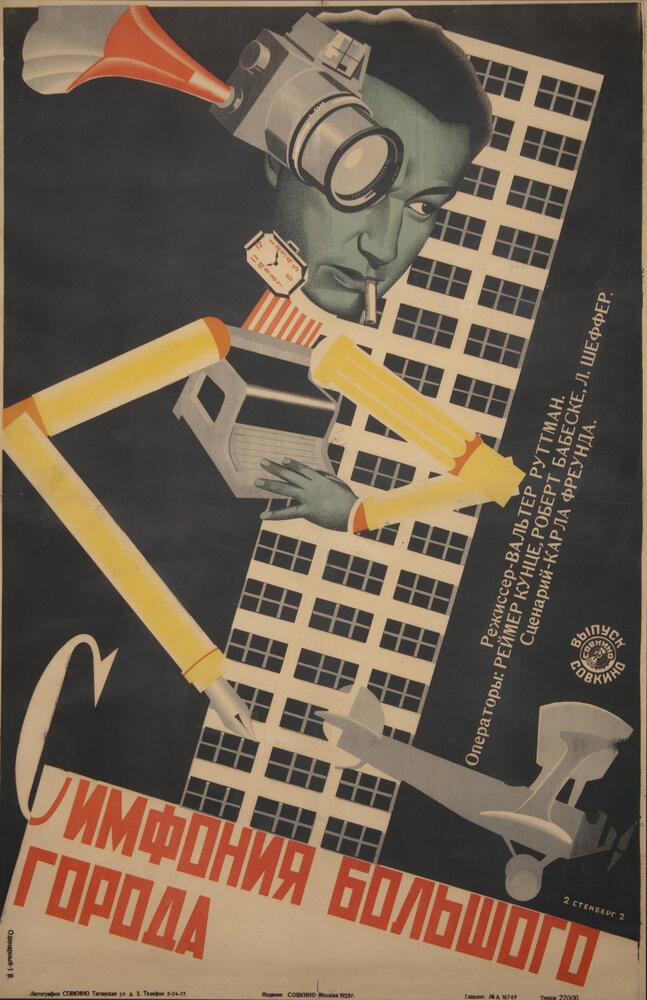 Overall black, yellow, white and orange. There is a man&#39;s head with a cigarette in his mouth. He has robotic arms and there is a skyscraper in the background.