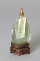 An aventurine quartz snuff bottle that has been shaped on the outside so that it looks like it is carved.