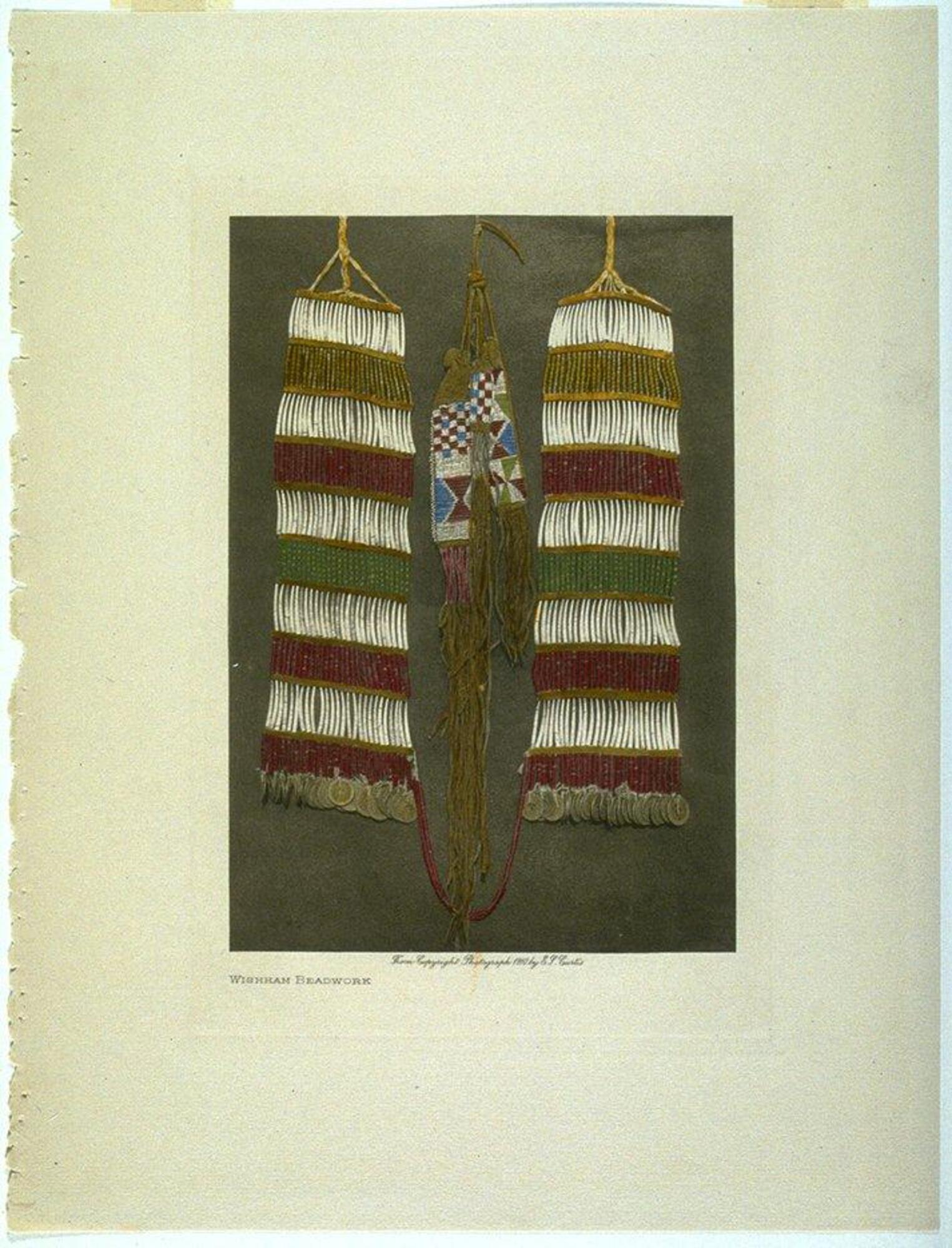 A hand-tinted photograph of woven beadwork. Two larger, identical rectangular pieces frame a smaller piece with multiple tassles in the center. 